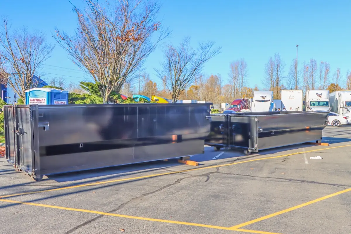 Professional dumpster rental service with roll-off container on residential driveway in Dallas